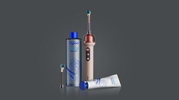 Dyson wet and dry vacuum cleaner is used to clean a pill on the tile floor.